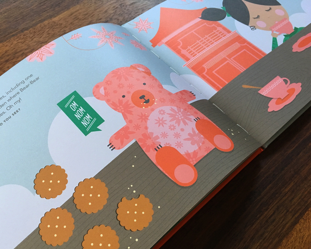Open book showing Bear-Bear and Neela with cookies and tea