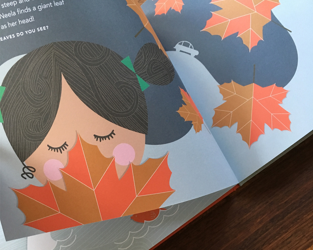 Open book showing Neela with a leaf as big as her head!
